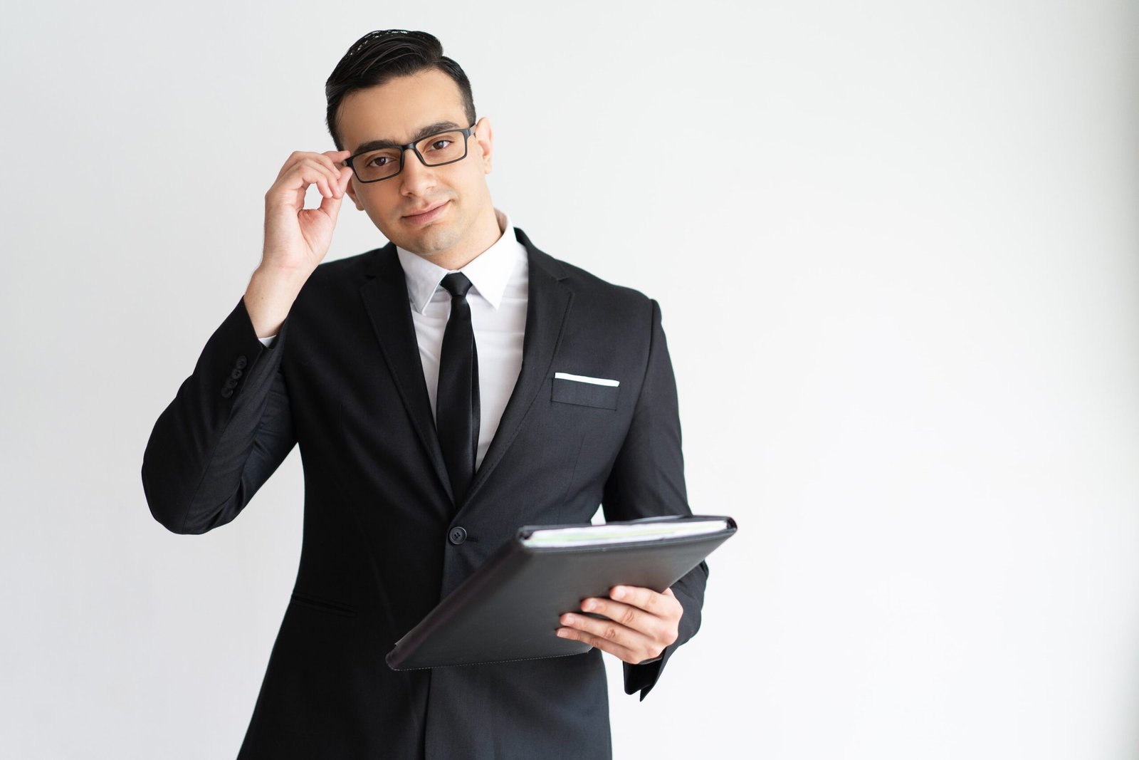 serious-handsome-young-businessman-adjusting-glasses-holding-folder-min
